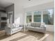 Sunlit living area with two sofas, hardwood floors, and large windows offering great views at 5074 Yosemite Ct # 1, Denver, CO 80238