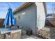 Back patio features outdoor dining set with umbrella and pavers at 5074 Yosemite Ct # 1, Denver, CO 80238