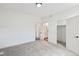 Bright bedroom with plush gray carpeting and white walls leading to closet and bathroom at 30355 E 161St Ave, Brighton, CO 80603