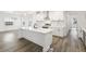 Modern kitchen with white cabinets, stainless steel appliances, and large island at 30355 E 161St Ave, Brighton, CO 80603