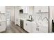 Modern kitchen boasts white cabinets, stainless appliances, and quartz countertops at 30355 E 161St Ave, Brighton, CO 80603