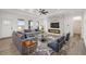 Bright living room with fireplace, ceiling fan, and views from multiple windows at 30355 E 161St Ave, Brighton, CO 80603