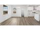 Spacious living room with hardwood floors and a view of the modern, white kitchen at 30355 E 161St Ave, Brighton, CO 80603