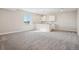 Finished basement includes carpet and kitchenette area with white cabinetry at 5930 S Platte Canyon Dr, Littleton, CO 80123