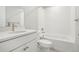 Bright bathroom features a white vanity with stone top, subway tile shower and tub at 5930 S Platte Canyon Dr, Littleton, CO 80123