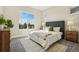 Bright bedroom features a large window with a view, plush carpet, and stylish neutral decor at 5930 S Platte Canyon Dr, Littleton, CO 80123