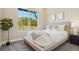 Cozy bedroom with large window overlooking backyard, neutral color scheme, and modern decor at 5930 S Platte Canyon Dr, Littleton, CO 80123
