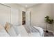 Serene bedroom featuring neutral tones, plush bedding, sliding closet doors, and modern decor at 5930 S Platte Canyon Dr, Littleton, CO 80123