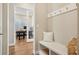 Welcoming entryway with bench seating, coat hooks, and view into the home office at 5930 S Platte Canyon Dr, Littleton, CO 80123