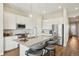 Bright kitchen features white cabinets, stainless steel appliances, a large island, and stylish pendant lighting at 5930 S Platte Canyon Dr, Littleton, CO 80123