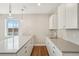 New kitchenette offers bright cabinetry, lots of counterspace, and recessed lighting at 5930 S Platte Canyon Dr, Littleton, CO 80123