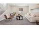 Finished basement living area features natural lighting, couch and stylish chairs at 5930 S Platte Canyon Dr, Littleton, CO 80123