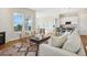 Open concept living room with fireplace, area rug, island bar and hardwood flooring at 5930 S Platte Canyon Dr, Littleton, CO 80123