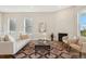 Comfortable living room with fireplace, area rug, and plenty of natural light at 5930 S Platte Canyon Dr, Littleton, CO 80123