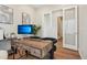 Home office featuring wood desk and flooring, modern artwork, and glass doors at 5930 S Platte Canyon Dr, Littleton, CO 80123
