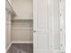 Bright walk-in closet with shelving and clothing rod adjacent to white paneled door at 5930 S Platte Canyon Dr, Littleton, CO 80123