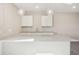 Finished basement featuring a wet bar with white cabinets and globe pendant lights at 5930 S Platte Canyon Dr, Littleton, CO 80123