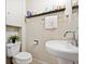 Clean bathroom featuring a stylish pedestal sink and bright window, offering a simple yet functional space at 2125 S Gilpin St, Denver, CO 80210