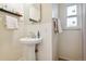 Clean bathroom featuring a stylish pedestal sink and bright window, offering a simple yet functional space at 2125 S Gilpin St, Denver, CO 80210