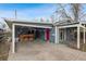 Charming home exterior with a covered parking area and red door at 2125 S Gilpin St, Denver, CO 80210
