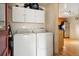 Laundry area featuring a washer and dryer with overhead cabinets at 2125 S Gilpin St, Denver, CO 80210