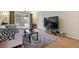 Bright living room featuring a plush sofa, stylish rug, and sliding glass doors with views of the outdoors at 2125 S Gilpin St, Denver, CO 80210