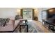 Bright living room featuring a plush sofa, stylish rug, and sliding glass doors with views of the outdoors at 2125 S Gilpin St, Denver, CO 80210