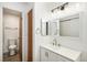 Clean, updated bathroom featuring a white vanity and a separate toilet/shower room at 8035 W Eastman Pl # 106, Lakewood, CO 80227