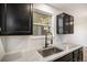 Modern kitchen sink with black fixtures and bright natural light from an ample window at 8035 W Eastman Pl # 106, Lakewood, CO 80227