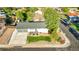 Aerial view showcases the house's location in a community with mature trees and well-maintained street at 7100 Saulsbury St, Arvada, CO 80003