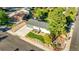 Aerial view highlights the property's curb appeal with a large driveway, attached garage, and landscaped yard at 7100 Saulsbury St, Arvada, CO 80003