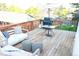 Cozy back deck features a grill, outdoor furniture and umbrella, perfect for entertaining at 7100 Saulsbury St, Arvada, CO 80003