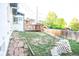 Large backyard features a patio deck area, lots of space for recreation, and block retaining wall at 7100 Saulsbury St, Arvada, CO 80003