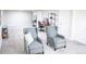 A spacious finished basement area with neutral paint, plush carpet, and two comfy chairs for relaxing or working at 7100 Saulsbury St, Arvada, CO 80003