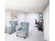 A spacious finished basement area with neutral paint, plush carpet, and two comfy chairs for relaxing or working at 7100 Saulsbury St, Arvada, CO 80003