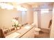 Bright bathroom featuring double sinks, tile floors, and a shower with a white shower curtain at 7100 Saulsbury St, Arvada, CO 80003