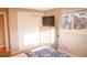 Bright bedroom with a closet and a window showing the view outside at 7100 Saulsbury St, Arvada, CO 80003