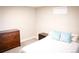 Bright bedroom features neutral walls, carpet, a window and a comfortable bed dressed with blue pillows at 7100 Saulsbury St, Arvada, CO 80003