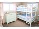 Charming bedroom featuring bunk beds, a dresser, and a bright window at 7100 Saulsbury St, Arvada, CO 80003