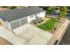 Aerial view of a single story home featuring a large driveway, attached garage, landscaped yard, and street view at 7100 Saulsbury St, Arvada, CO 80003
