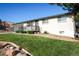 Charming single story home featuring a well-kept front yard, flowers, and a cozy front porch at 7100 Saulsbury St, Arvada, CO 80003