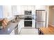 Modern kitchen with stainless steel appliances and granite countertops is great for cooking at 7100 Saulsbury St, Arvada, CO 80003
