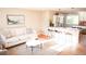 Bright, modern living room open to kitchen features stylish furnishings and an open concept design at 7100 Saulsbury St, Arvada, CO 80003