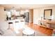 Open concept living and kitchen area with hardwood floors, pendant lighting, breakfast bar and stainless steel appliances at 7100 Saulsbury St, Arvada, CO 80003