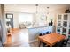 Inviting living room view featuring dining area and hardwood floors, with light and bright feel at 7100 Saulsbury St, Arvada, CO 80003