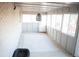 Bright and airy sunroom with brick walls, lots of windows, and a textured rug creating a versatile indoor space at 7100 Saulsbury St, Arvada, CO 80003