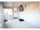 A versatile sunroom with brick walls, lots of windows, and a textured rug creating a relaxing indoor space at 7100 Saulsbury St, Arvada, CO 80003