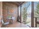 Cozy front porch featuring a decorative brick wall and outdoor seating at 2080 Leyden St, Denver, CO 80207