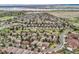 Scenic aerial shot of a community near a large lake, featuring tree-lined streets, beautiful homes, and a peaceful atmosphere at 9825 S Iris Ct, Littleton, CO 80127