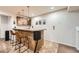 Basement bar with wine rack, pendant lighting, granite countertop and seating for a relaxed entertainment space at 9825 S Iris Ct, Littleton, CO 80127
